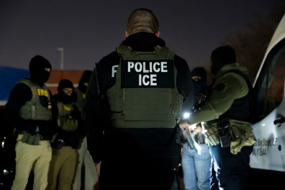 ICE agents gather in the dark.